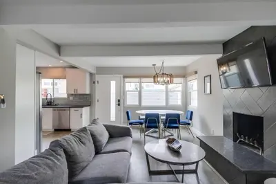a living room with a couch and a table at Mission Beach Escape Near Ocean and Bay with Private Balcony BBQ and Garage Parking in San Diego