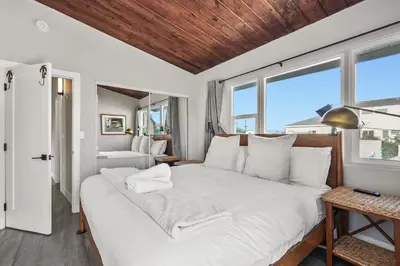 a large white bed in a room with windows at Mission Beach Escape Near Ocean and Bay with Private Balcony BBQ and Garage Parking in San Diego
