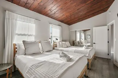 a bedroom with two beds and a wooden ceiling at Mission Beach Escape Near Ocean and Bay with Private Balcony BBQ and Garage Parking in San Diego