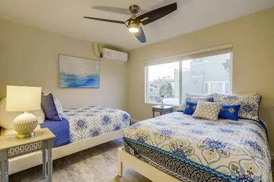 a bedroom with two beds and a window at Bayside Retreat with Water Views Near Beach with AC and Private Patio in San Diego