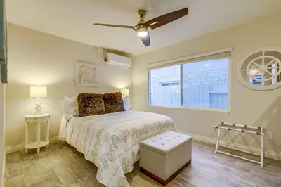 a bedroom with a bed with a ceiling fan and a window at Bayside Retreat with Water Views Near Beach with AC and Private Patio in San Diego