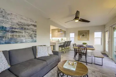 a living room with a couch and a table at Bayside Retreat with Water Views Near Beach with AC and Private Patio in San Diego