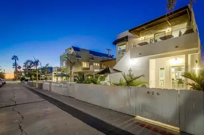 a house with a fence in front of a street at Bayside Retreat with Water Views Near Beach with AC and Private Patio in San Diego
