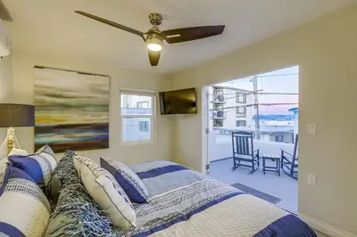 a bedroom with a bed and a ceiling fan at Bayside Retreat with Water Views Near Beach with AC and Private Patio in San Diego