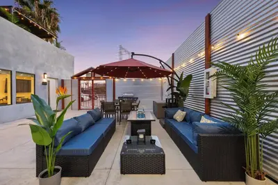 a patio with blue couches and an umbrella at Harborside Suite 10 with Hot Tub and King Bed in San Diego