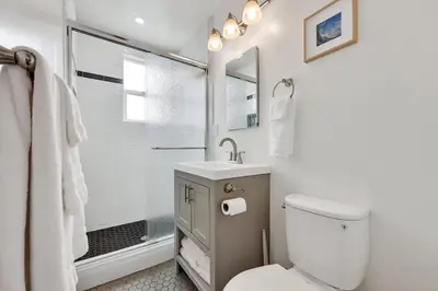 a bathroom with a toilet and a sink and a shower at Harborside Suite 10 with Hot Tub and King Bed in San Diego