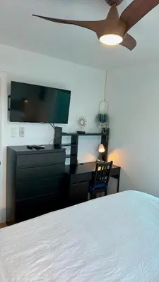 a bedroom with a bed and a dresser with a flat screen tv at Harborside Suite 10 with Hot Tub and King Bed in San Diego