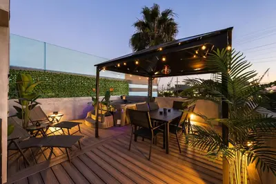 a patio with a table and chairs on a deck at Harborside Suite 08 with Hot Tub in San Diego
