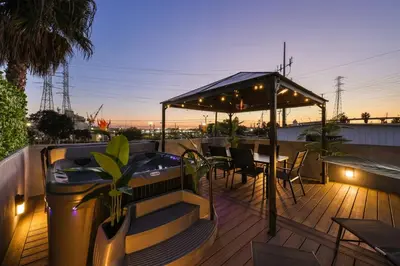 a deck with a hot tub and a table and chairs at Harborside Suite 08 with Hot Tub in San Diego
