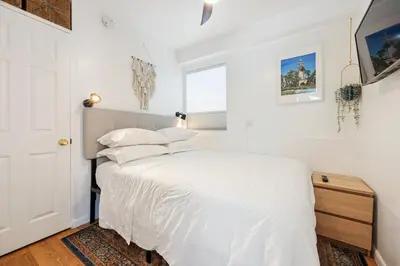 a white bedroom with a bed and a window at Harborside Suite 08 with Hot Tub in San Diego