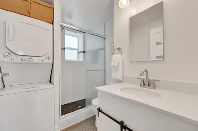a white bathroom with a sink and a shower at Harborside Suite 06 with Hot Tub and King Beds in San Diego
