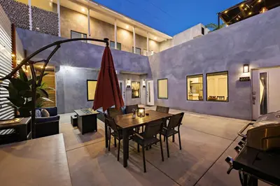 a dining room with a table and a red umbrella at Harborside Suite 06 with Hot Tub and King Beds in San Diego