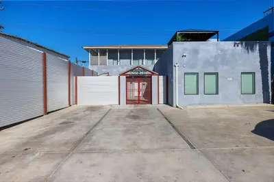 a garage with a red door in front of a building at Harborside Suite 04 with Hot Tub and King Bed in San Diego