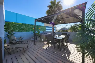 a deck with a table and chairs and an umbrella at Harborside Suite 04 with Hot Tub and King Bed in San Diego