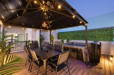 a deck with a table and chairs and a hot tub at Harborside Suite 04 with Hot Tub and King Bed in San Diego