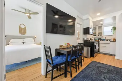 a bedroom with a bed and a table and chairs at Harborside Suite 04 with Hot Tub and King Bed in San Diego