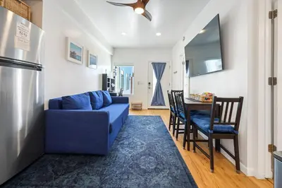 a living room with a blue couch and a table at Harborside Suite 04 with Hot Tub and King Bed in San Diego