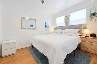 a white bedroom with a large bed and two windows at Harborside Suite 04 with Hot Tub and King Bed in San Diego