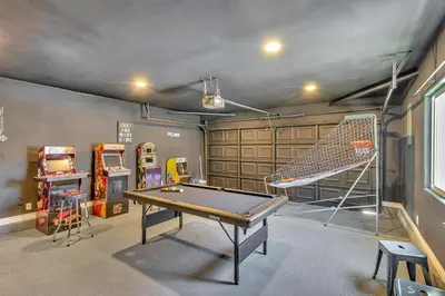 a room with a ping pong table and arcade games at Tropical Bliss - 5BR Pool Spa Games 12 min to dwtn in San Diego