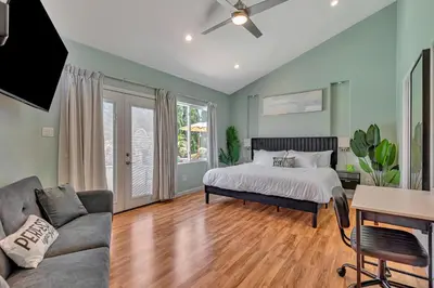 a bedroom with a bed and a couch at Tropical Bliss - 5BR Pool Spa Games 12 min to dwtn in San Diego