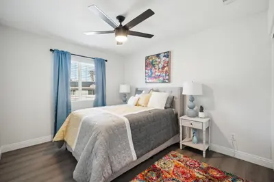 a bedroom with a bed and a ceiling fan at Carroll Family Retreat in San Jacinto