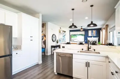 a kitchen with white cabinets and a sink at Carroll Family Retreat in San Jacinto