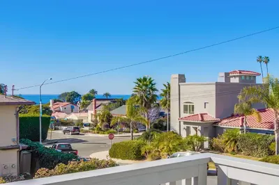 a view of a street with palm trees and houses at ocean views 3 blocks to beach AC downstairs in San Diego