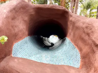 a water fountain in a fake rock formation at Paradise Lagoon Resort Style Pool Getaway in La Mesa