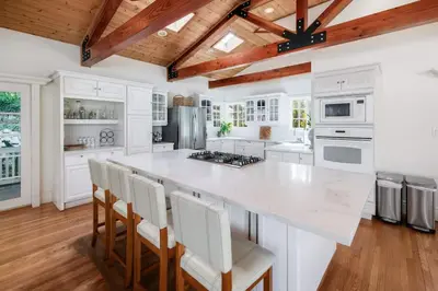 a large white kitchen with a large white counter top at Paradise Lagoon Resort Style Pool Getaway in La Mesa