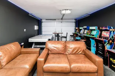 a living room with a leather couch in a garage at Paradise Lagoon Resort Style Pool Getaway in La Mesa