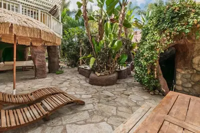 a patio with a bench and trees and a building at Paradise Lagoon Resort Style Pool Getaway in La Mesa