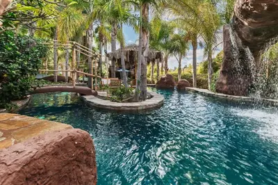 a pool in a resort with palm trees at Paradise Lagoon Resort Style Pool Getaway in La Mesa