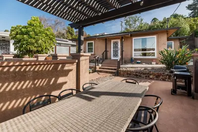 a patio with a table and chairs and a house at Downtown La Mesa gem in La Mesa