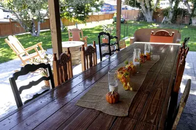 a long wooden table with pumpkins and candles on it at Near SoCal sports complex, Frontwave Arena-Sold in Oceanside