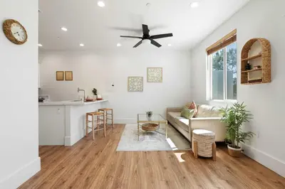 a living room with a couch and a ceiling fan at The Little Oasis in Escondido