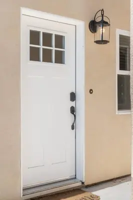 a white door with a window and a lamp at The Oasis in Escondido