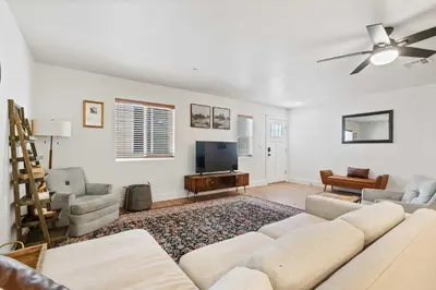 a living room with a couch and a flat screen tv at The Oasis in Escondido