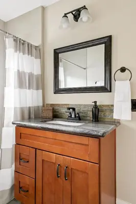 a bathroom with a sink and a mirror at Cozy 3BR Steps to Dining & Attractions in San Diego