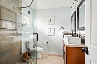 a bathroom with a shower and a toilet and a sink at Cozy 3BR Steps to Dining & Attractions in San Diego
