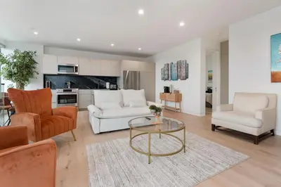 a living room with white furniture and a glass table at Ocean View Luxury Living in Carlsbad