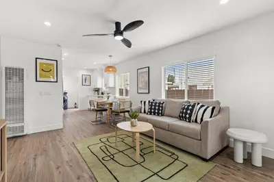 a living room with a couch and a table at The Stylish Cozy Bungalow in North Park in San Diego