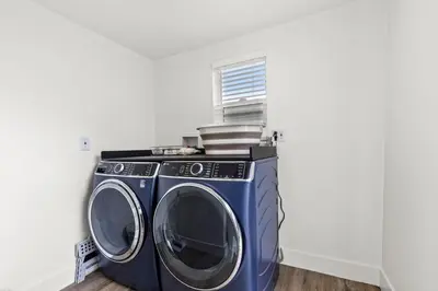 a washing machine in a laundry room with a window at The Stylish Cozy Bungalow in North Park in San Diego
