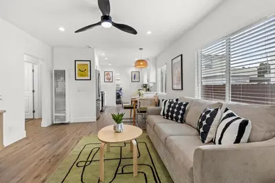 a living room with a couch and a ceiling fan at The Stylish Cozy Bungalow in North Park in San Diego