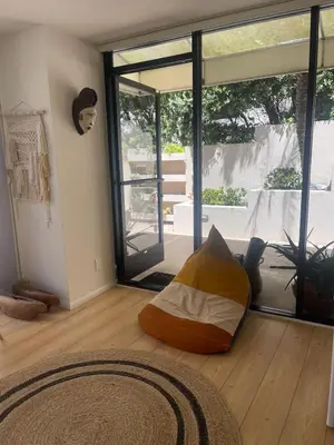 a living room with a large sliding glass door at La Jolla Suite & Beach Access in San Diego