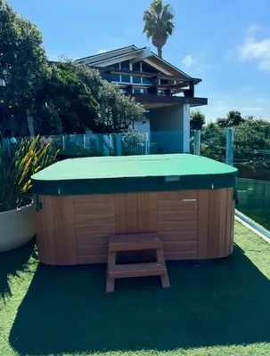 a hot tub with a bench in front of a house at La Jolla Suite & Beach Access in San Diego