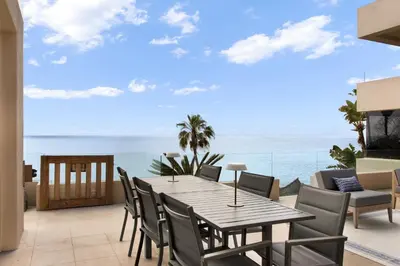 a table and chairs on a balcony with the ocean at La Jolla Suite & Beach Access in San Diego