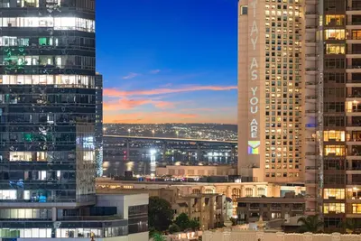 a city skyline with tall buildings at night at Little Italy Marina Condo by the Ocean in San Diego