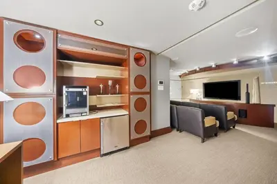 a living room with a desk and a television at Little Italy Marina Condo by the Ocean in San Diego