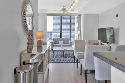 a living room with white furniture and a mirror at Gaslamp 2 bed Penthouse Petco Park Convention Ctr in San Diego