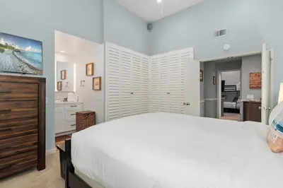 a bedroom with a large white bed and a television at Breeze & Bridle - TC530J in Solana Beach